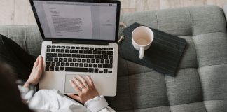 Woman sitting on a couch writing a marketing strategy, copywriting